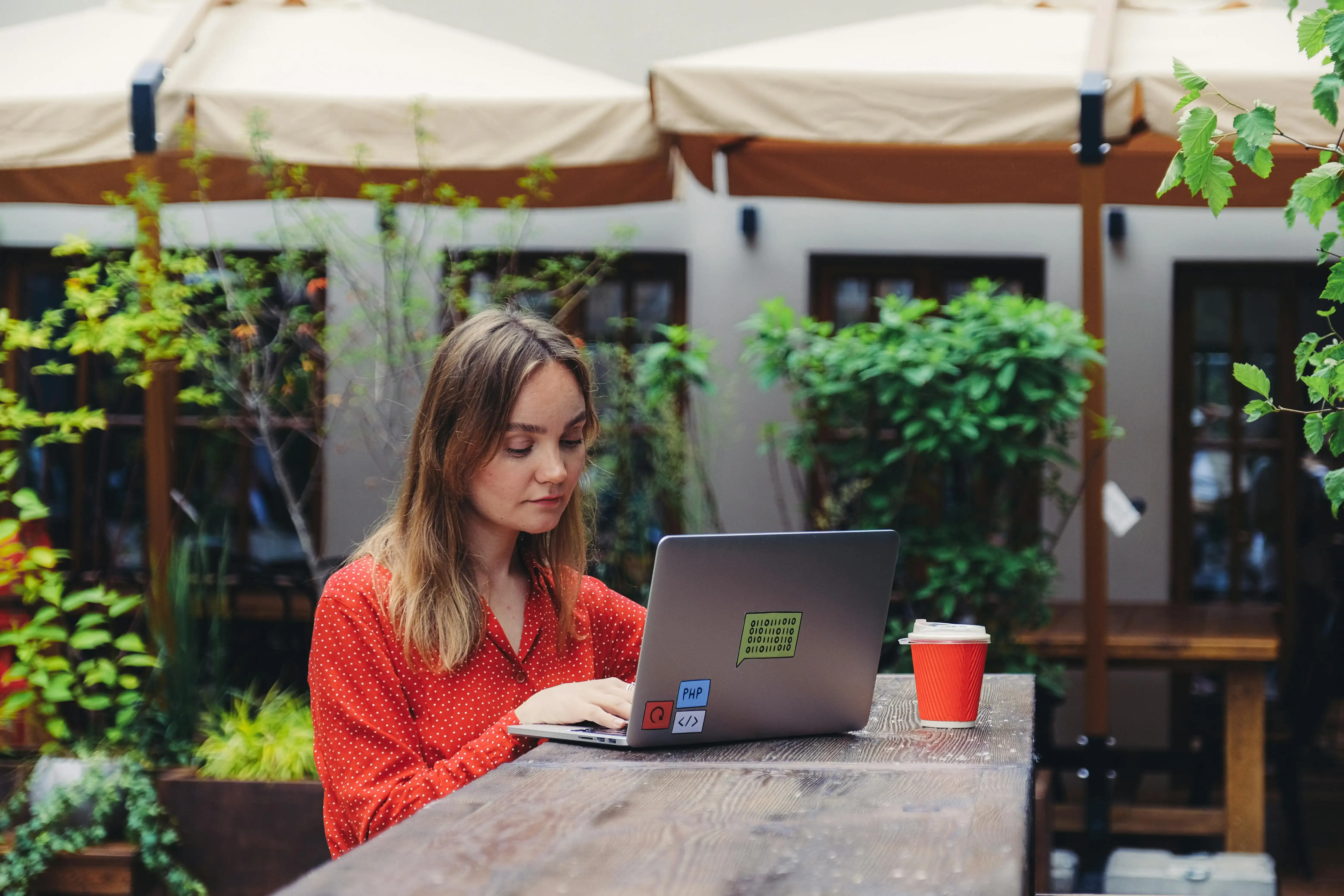 Person working on a laptop at an outdoor café