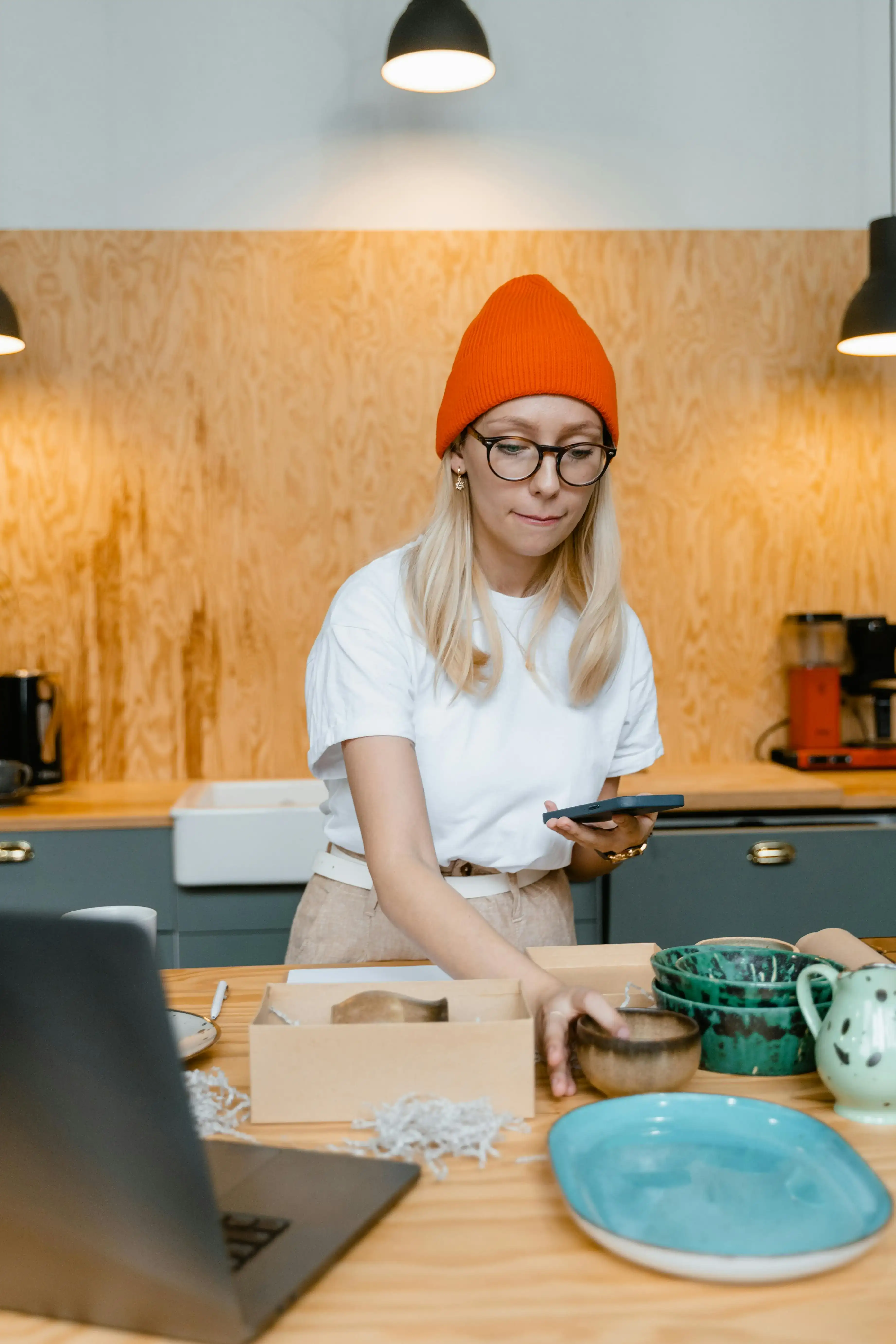 Woman packaging handmade ceramics for her online business