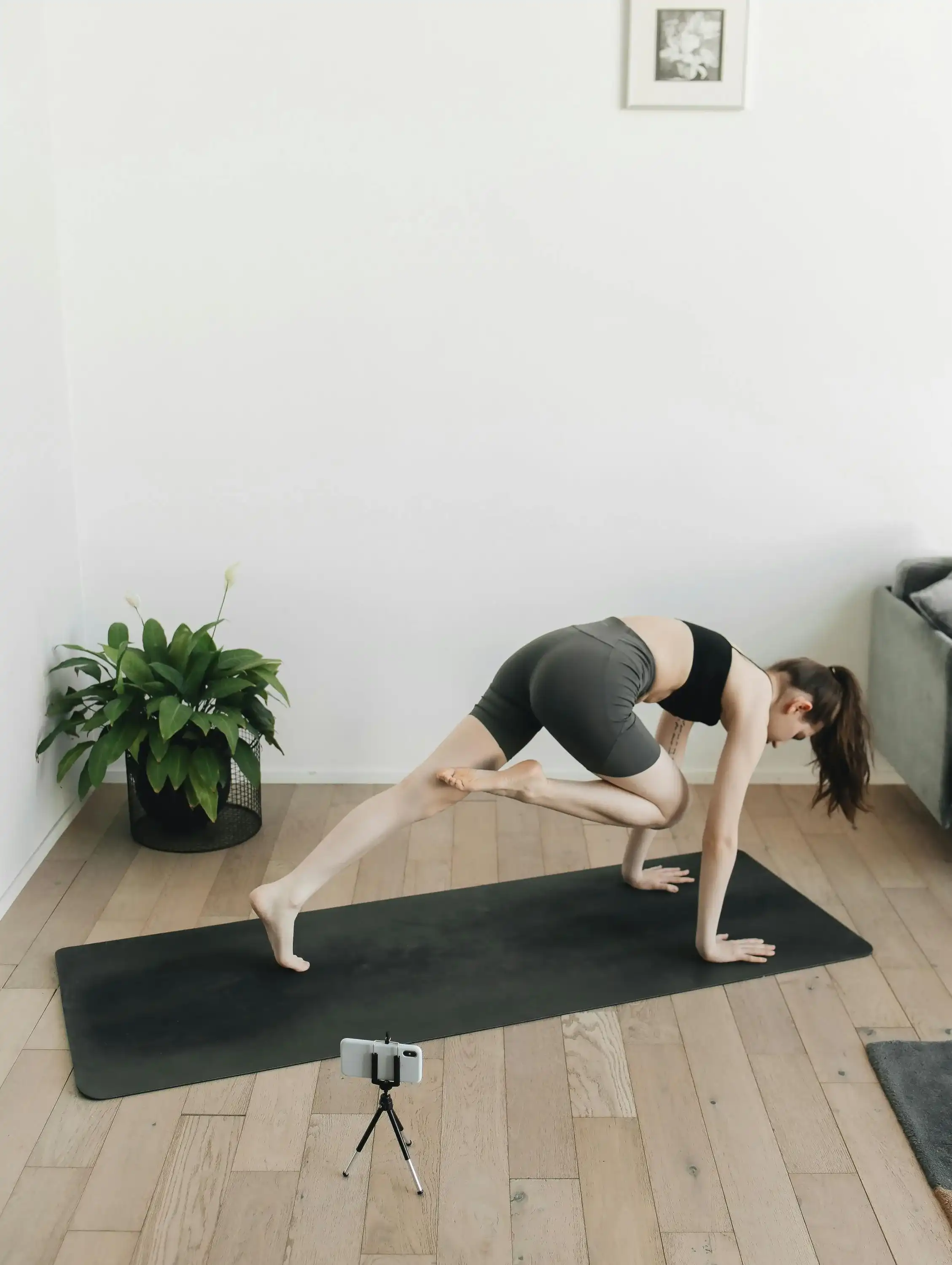 Yoga instructor with smartphone for online class